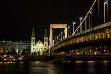Fototapeta na wymiar View of City Mother Church of the Blessed Virgin and Elisabeth Bridge in Budapest at night. Hungary