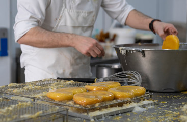 artisan pastry chef placing cake on metal tray