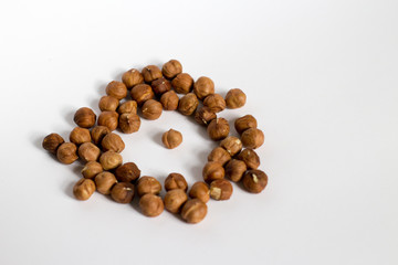  handful of nuts on a white background, almonds and hazelnuts, nest