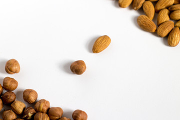  handful of nuts on a white background, almonds and hazelnuts