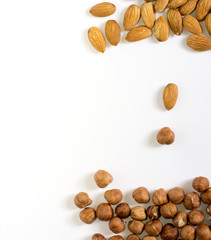  handful of nuts on a white background, almonds and hazelnuts