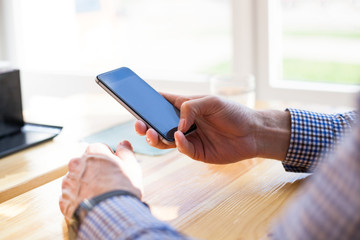 Male hands using modern smartphone, businessman typing text message and working on cellphone, cover page template for website. 