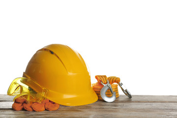 Set of safety equipment on table against white background