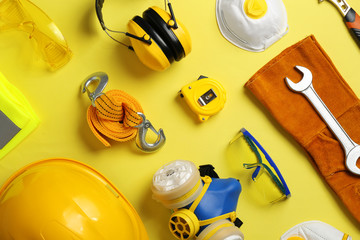 Flat lay composition with safety equipment on color background