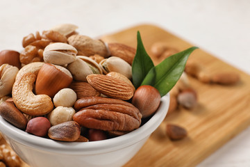 Bowl with organic mixed nuts on table, closeup