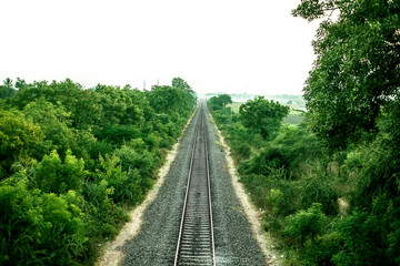 Green fields with railways tracks in center isolated on white.