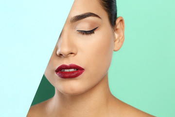 Young woman wearing beautiful lipstick on color background