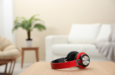 Stylish headphones on table indoors. Space for text