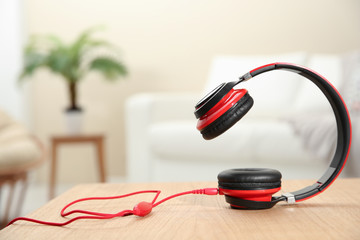 Stylish headphones on table indoors. Space for text