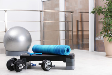 Set of fitness equipment of floor indoors. Space for text