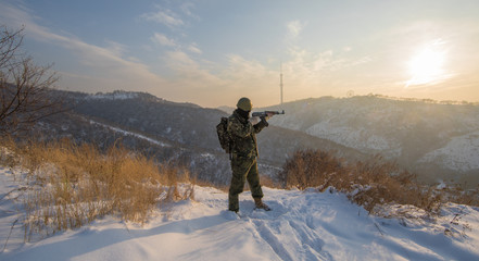 military with a gun on the mountain in winter, military operation