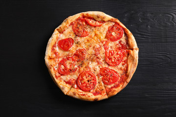 Hot cheese pizza Margherita on wooden table, top view