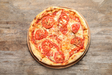 Hot cheese pizza Margherita on wooden table, top view