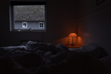 early morning in the bedroom, window and bedside lamp