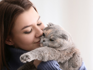Portrait of young woman with her cute cat