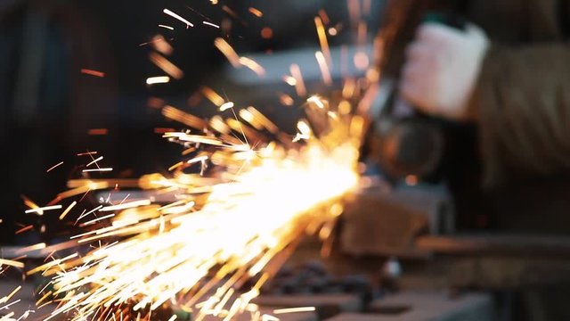 Industrial concept. Fire sparkles made by the grinder
