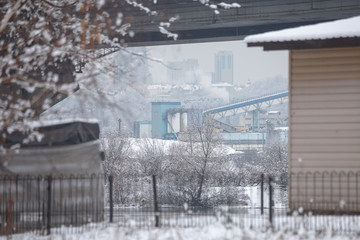 Fototapeta na wymiar Winter is cloudy weather. Industrial zone in the southern suburbs of Kyiv on the right bank of the Dnipro River. Ukraine Feb. 6, 2019