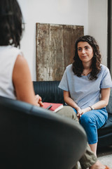 Psychotherapy session, woman talking to his psychologist in the studio