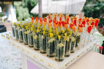 Many glasses of fruit prepared for lemonade.