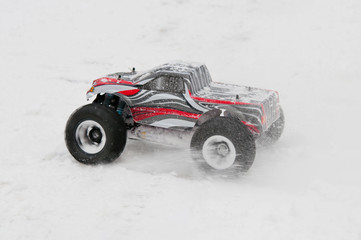 Radio-controlled monster starts on a snowy road.