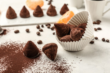 Tasty sweet truffles on white table