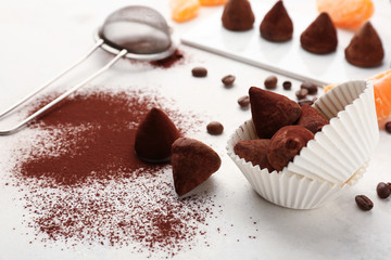 Tasty sweet truffles on white table