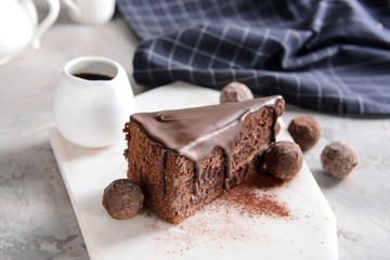 Piece of tasty chocolate cake on table