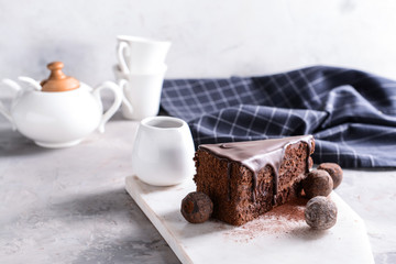 Piece of tasty chocolate cake on table