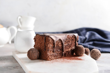 Piece of tasty chocolate cake on table