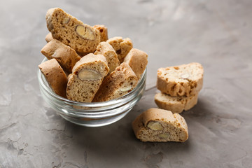 Bowl with tasty Italian biscotti on grey table