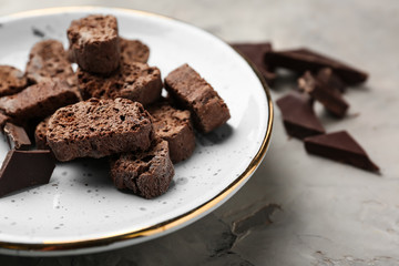 Plate with tasty Italian biscotti on grey table