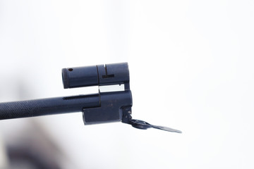 The muzzle of the rifle on a light background