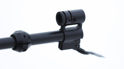 The muzzle of the rifle on a light background