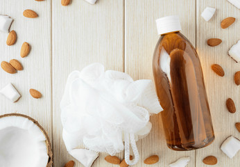Beautiful background with plastic bottle with almond and coconut. - 248001481