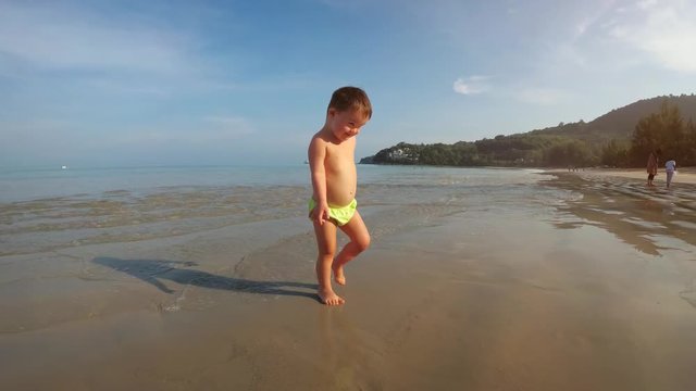 Cute Toddler Plays at the Beach. Ultra HD 4k stock footage