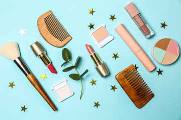 Set of makeup cosmetics with accessories on color background