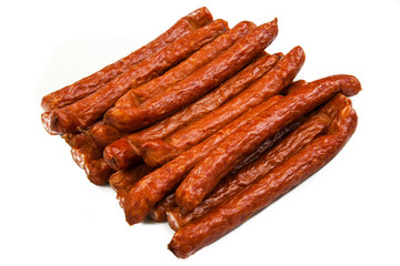 Bunch of whole hunted sausages on a white plate. Isolated on white background. Closeup