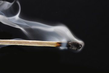 burned match stick on black