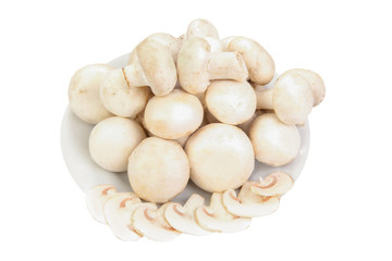pile of champignon mushrooms on a plate isolated on white background