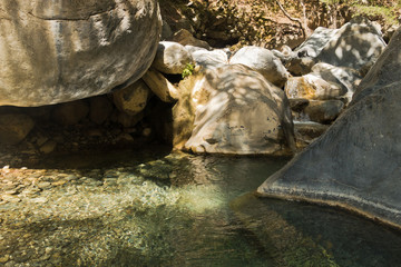 Crystal clear water of a cold mountain creek at rocky terrain of Samaria gorge, south west part of...