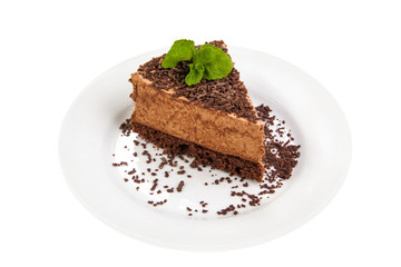 Fototapeta na wymiar Piece of cake. Chocolate biscuit with chocolate souffle on a white plate on a white background