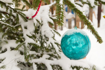 Christmas toy hanging on the tree outside in winter