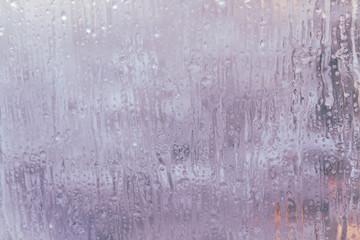 Frozen window in winter with drops and drips