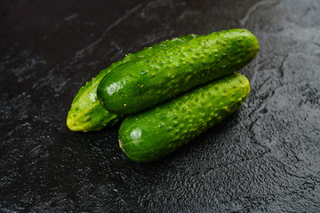 Fresh green cucumber  on black background