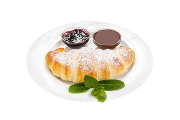 Croissant on a white plate, sprinkled with powdered sugar, with jam on a white background