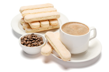 White ceramic cup of coffee with a savoiardi ladyfinger cookie on a plate