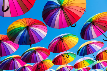 Many colorful umbrellas. Rainbow gay pride protection - obrazy, fototapety, plakaty