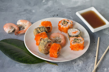 delicious sushi rolls with fresh fish caviar and soy sauce useful