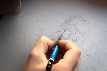 Hands drawing a cartoon