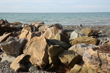 rocks of large stones on the beach of the sea